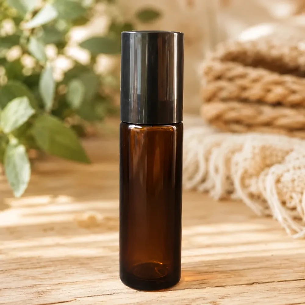 A 10ml amber glass roller ball bottle with a black lid